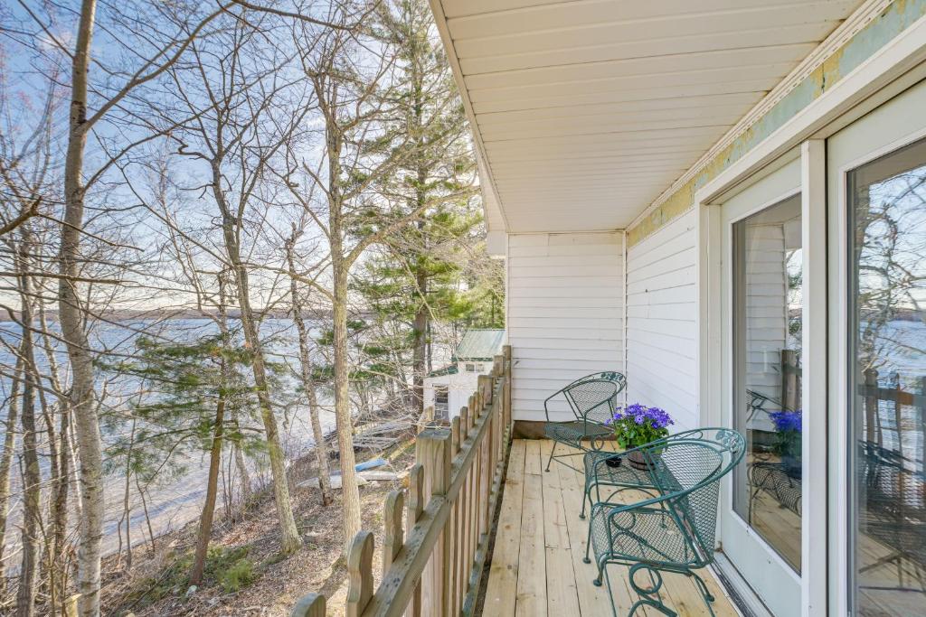 a porch with two chairs and a view of the water at Waterfront Hampden Home on Hermon Pond! in Hampden