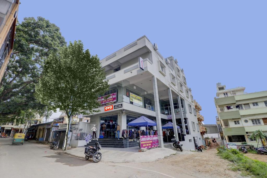 un edificio con una motocicleta estacionada frente a él en Flagship Sai International Near Nagasandra Metro Station en Bangalore