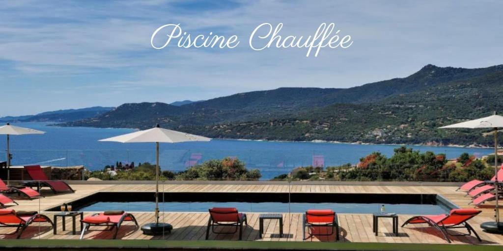 a swimming pool with chairs and umbrellas next to the water at Résidence & Hôtel Aria Marina in Propriano