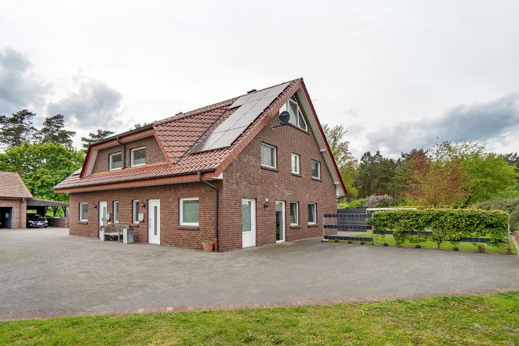 a large brick house with a large driveway at Ferienwohnung in Spelle in Spelle