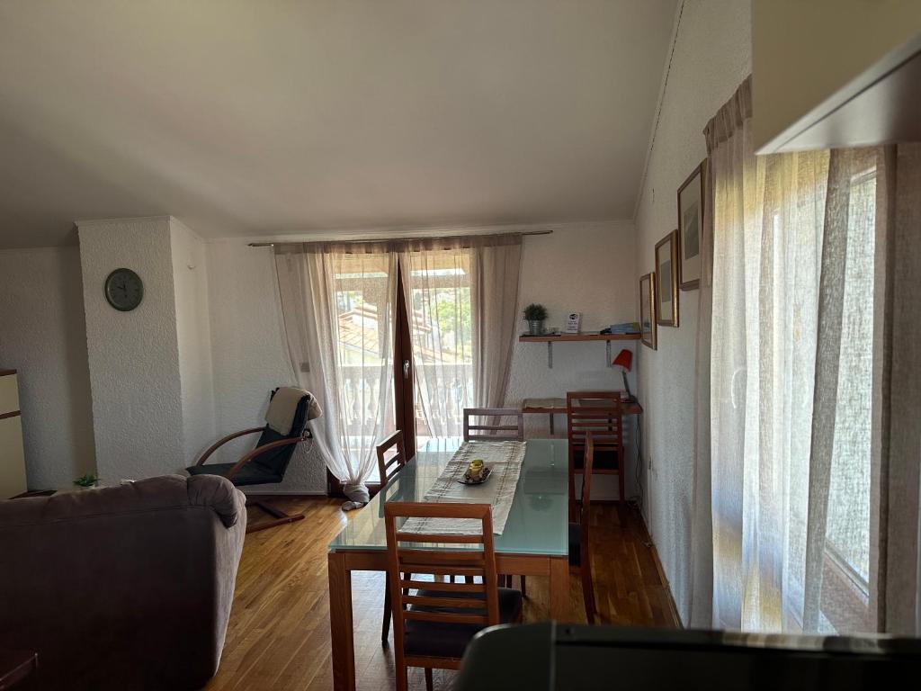 a living room with a table and chairs at Apartment Peloža 1 in Poreč