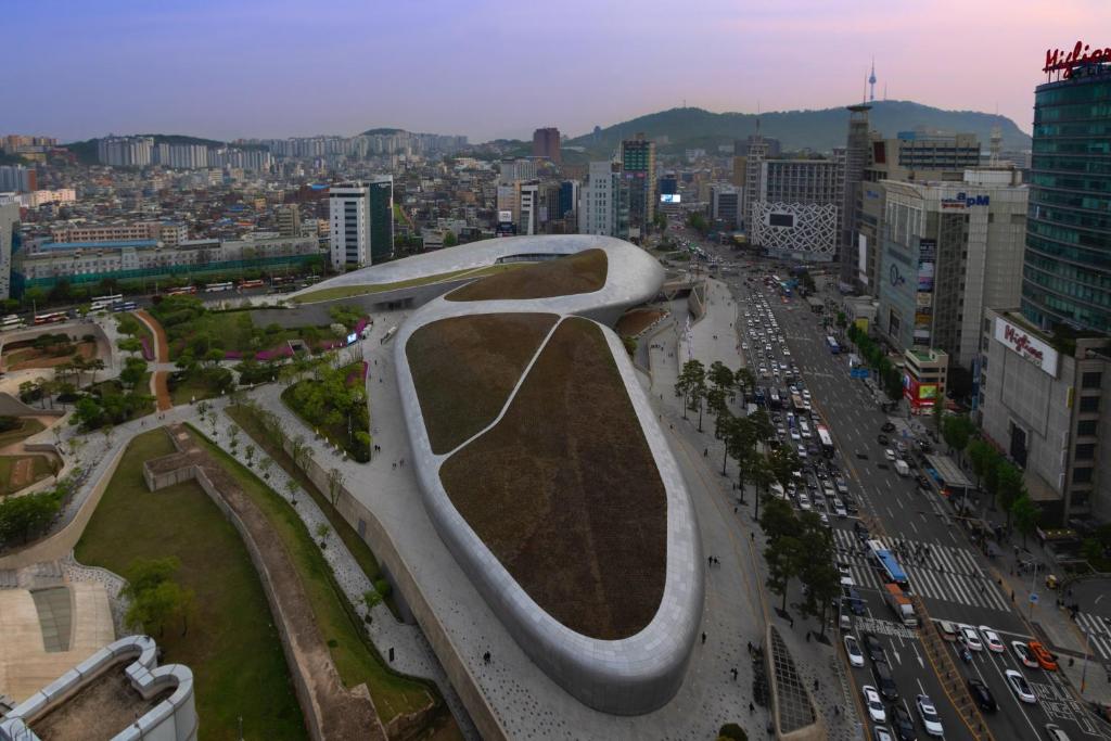 a rendering of a building in a city at "GRAND OPENED" Maxtyle Guesthouse Dongdaemun in Seoul