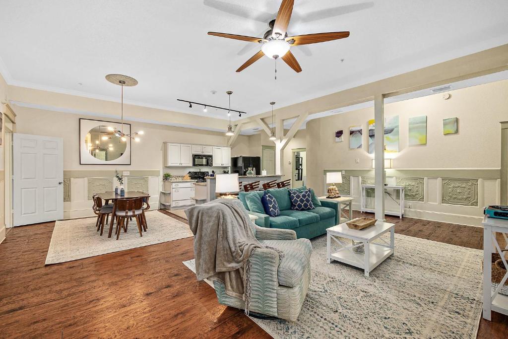 a living room with a blue couch and a kitchen at The Ray- 1st Floor Charming Condo- Walk to Downtown in St. Augustine