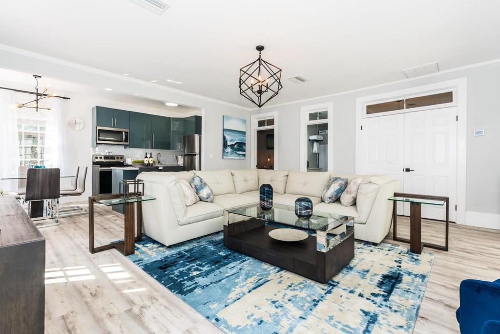 a living room with a white couch and a table at 20 Hypolita - Luxury Downtown Apartment in Saint Augustine
