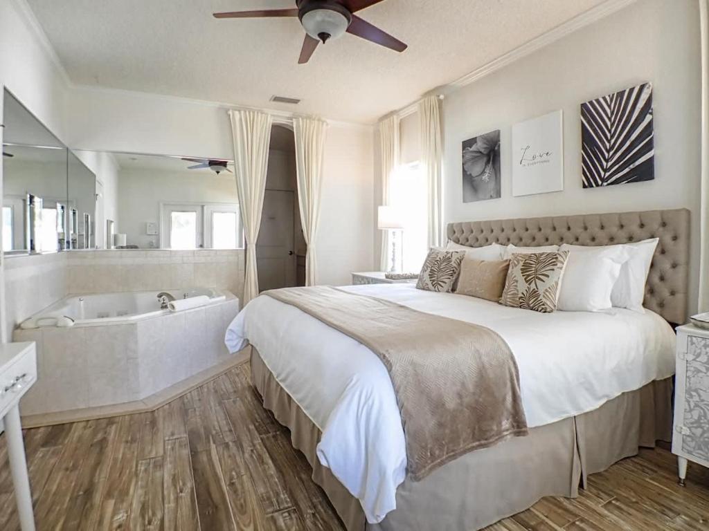 ein Schlafzimmer mit einem großen Bett und einer Badewanne in der Unterkunft Private Romantic Retreat Mins DWTN Beach in St. Augustine