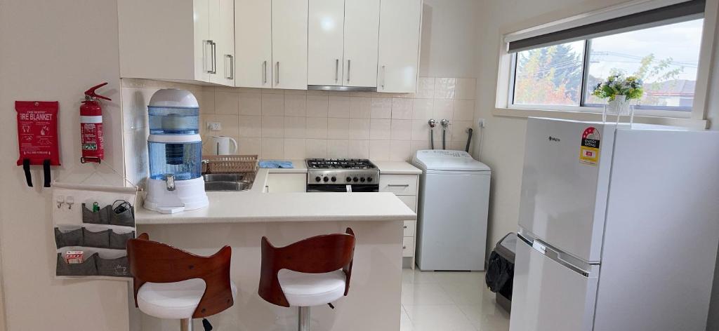 a kitchen with white appliances and a white refrigerator at One bedroom Apartment in Local shopping mall in Melbourne