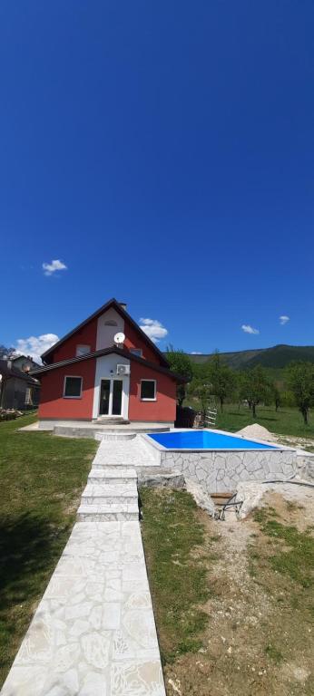 a house with a swimming pool in front of a house at Smjestaj na selu Stankovic - Pliva in Šipovo