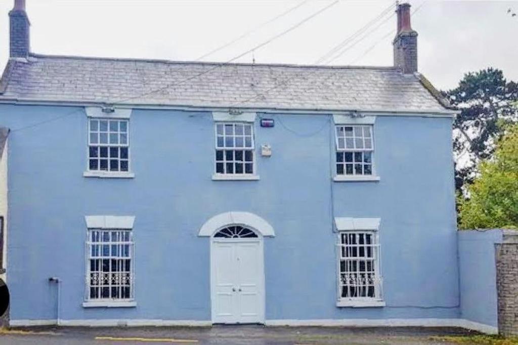 una casa blu con una porta bianca di Beautiful 4-Bed House in Kildare a Kildare