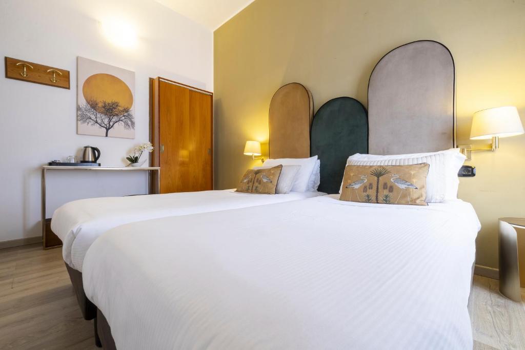 Postel nebo postele na pokoji v ubytování Hotel Bagliori