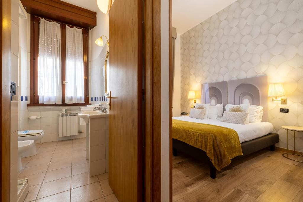 Postel nebo postele na pokoji v ubytování Hotel Bagliori