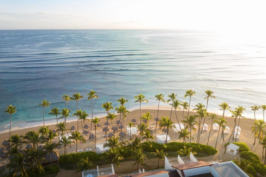 an aerial view of a beach with palm trees and the ocean at Breathless Punta Cana Resort & Spa - Adults Only - All Inclusive in Punta Cana