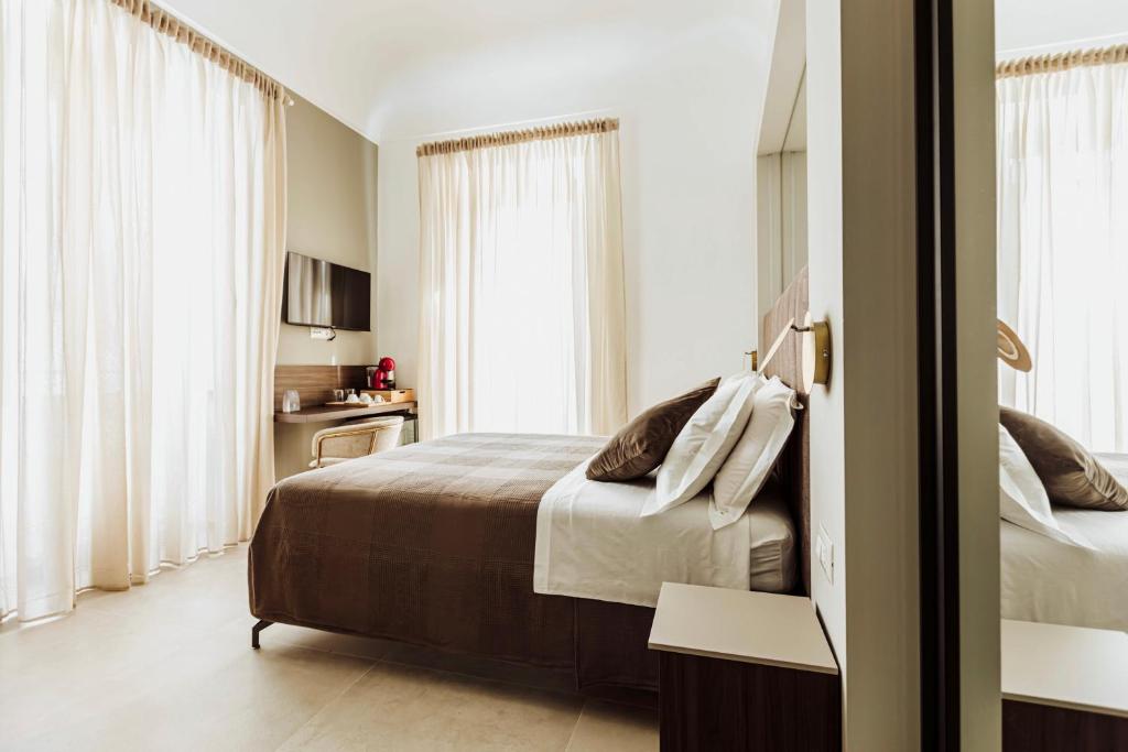 Postel nebo postele na pokoji v ubytování Le Grazie Relais & Spa