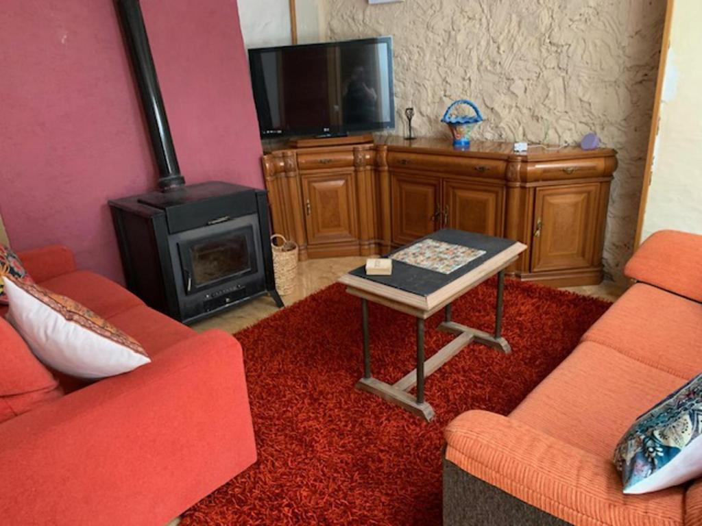 a living room with a couch and a stove at Beautiful 3-Bed Town House with garden in Sax in Sax