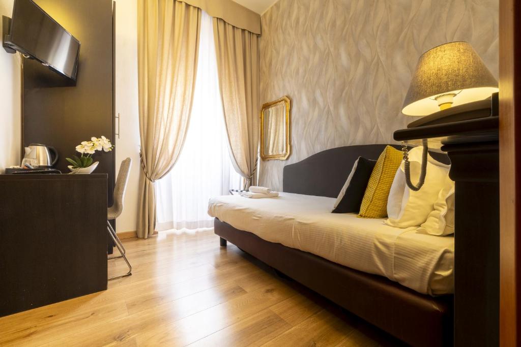 Postel nebo postele na pokoji v ubytování Hotel Bagliori
