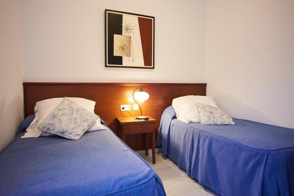 Postel nebo postele na pokoji v ubytování Apartamentos San Andres