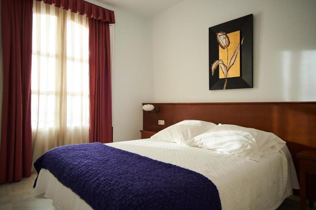 Postel nebo postele na pokoji v ubytování Apartamentos San Andres