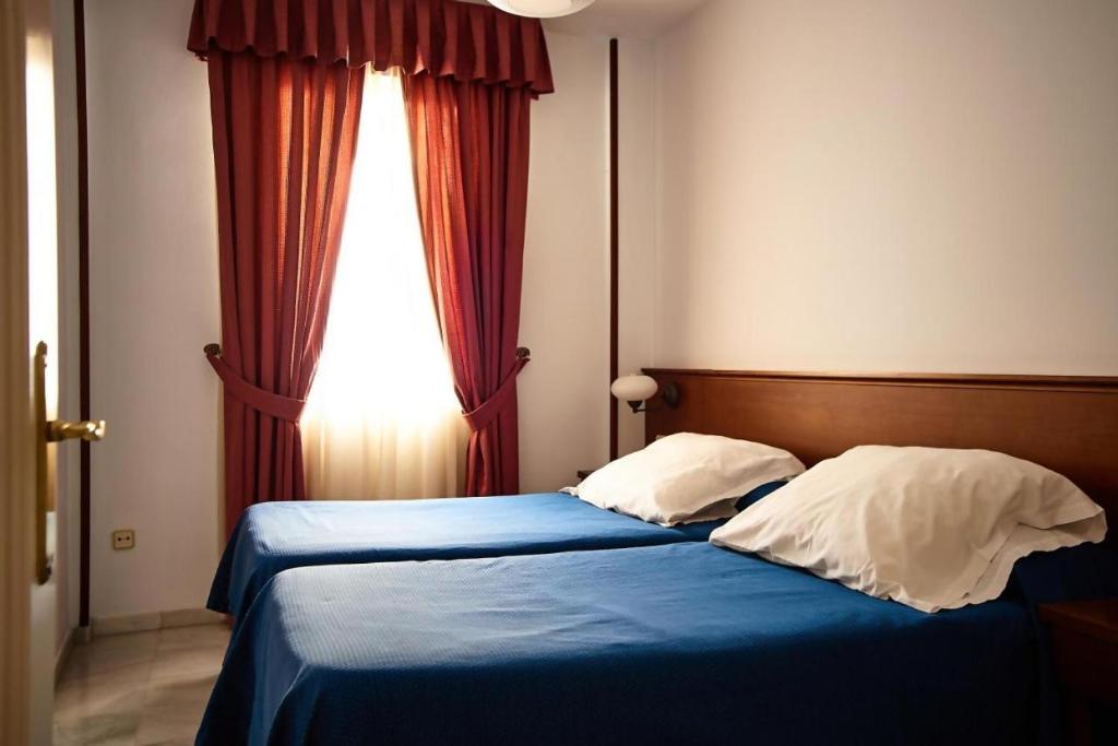 Postel nebo postele na pokoji v ubytování Apartamentos San Andres