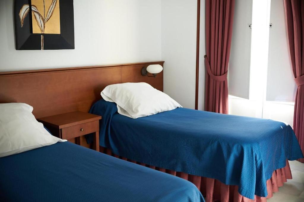 Postel nebo postele na pokoji v ubytování Apartamentos San Andres
