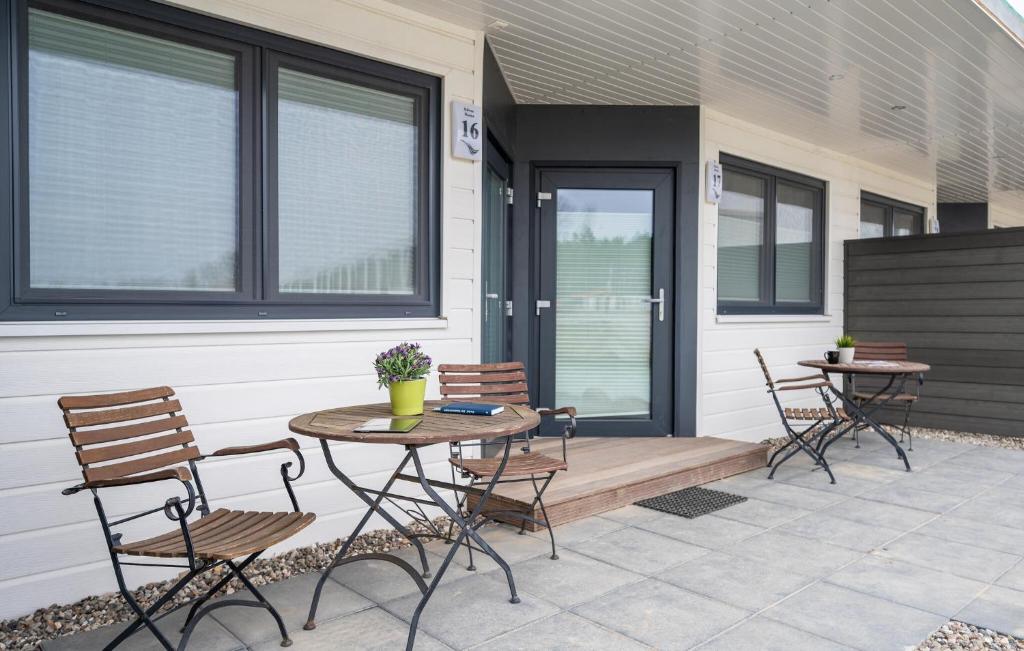a patio with two chairs and a table on a house at Apartments Waterfront in Sagard