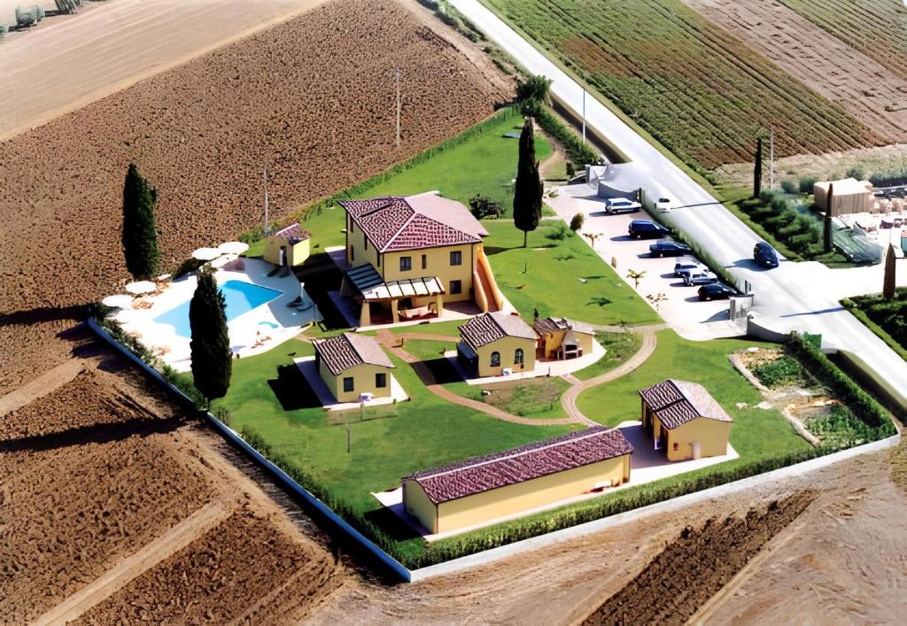 an aerial view of a house in a field at Podere Tre Cipressi in Campiglia Marittima