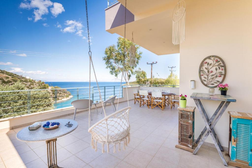 a balcony with a view of the ocean at Spacious Villa by the sea in Pefkali