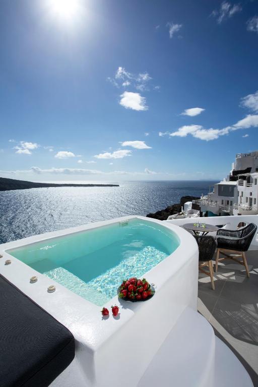 a swimming pool on the deck of a cruise ship at ArmonOia Luxury Caves in Oia