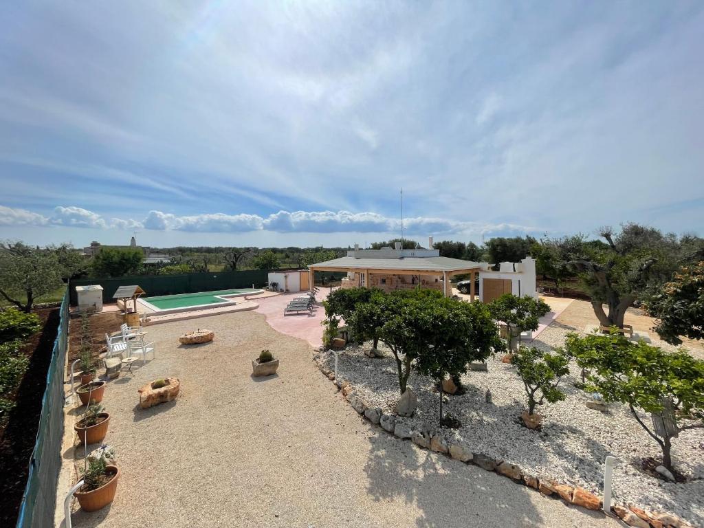 an aerial view of a house with a swimming pool at Trullo Del Salento in San Vito dei Normanni