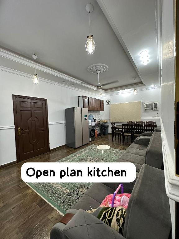 an open plan kitchen and living room with a couch at شقة مؤثثة قريبه من المسجد النبوي in Sulţānah
