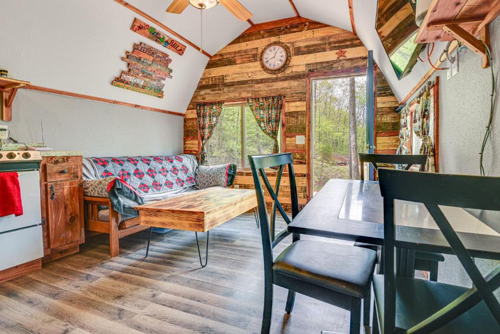 a living room with a couch and a table at Inviting Des Arc Cabin with Fire Pit and Deck! in Des Arc
