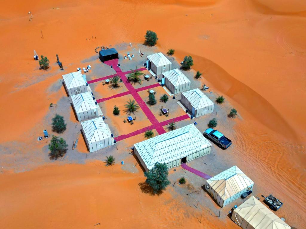 an aerial view of a building in the desert at Merzouga Luxury Tent in Merzouga