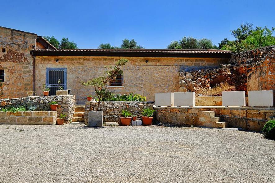 a stone building with two white refrigerators in front of it at Masseria Bianca in Taurisano