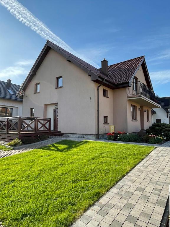 a house with a grassy yard in front of it at Willa Kinga in Władysławowo