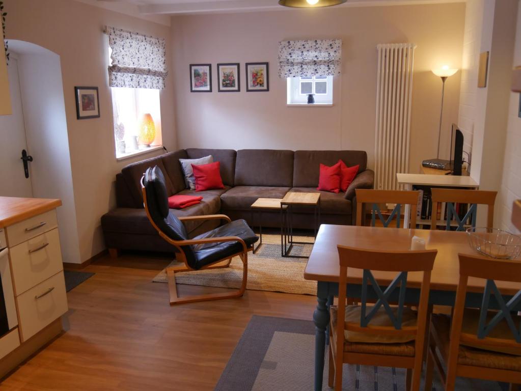 a living room with a couch and a table at Lindenhof, Wohnung 1, Giebel in Vipperow