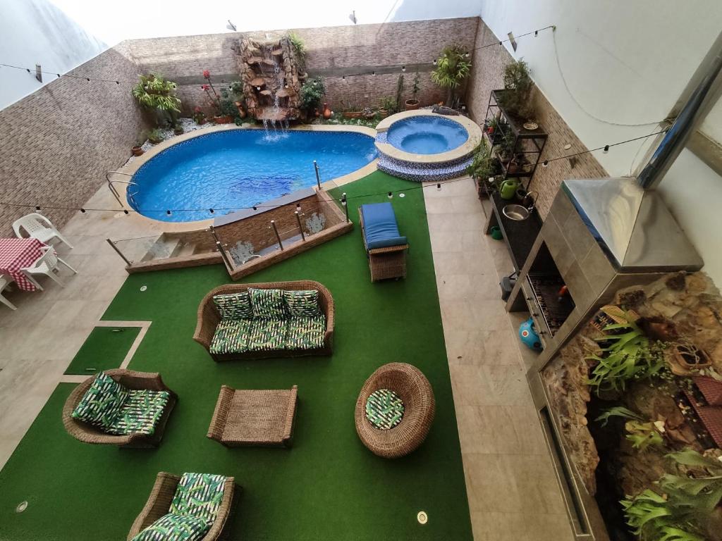una vista sul tetto di una piscina con tavoli e sedie di Encantadora Casa, Ubicación Ideal en Bucaramanga a Bucaramanga