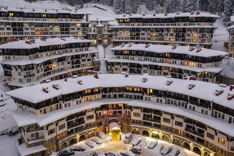 a group of buildings with snow on them at Grand Monastery Pamporovo Luxury Apartment in Pamporovo