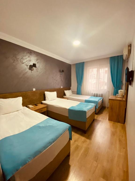 Postel nebo postele na pokoji v ubytování Malkoç Hotel