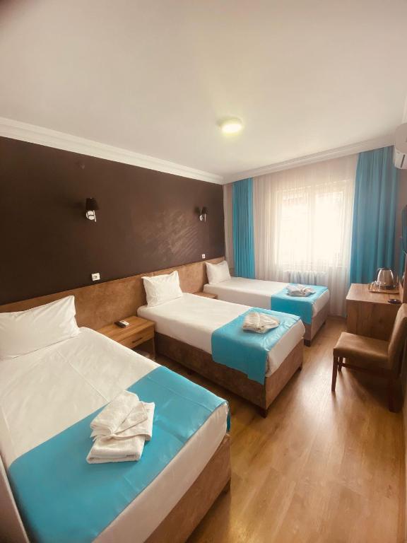 Postel nebo postele na pokoji v ubytování Malkoç Hotel