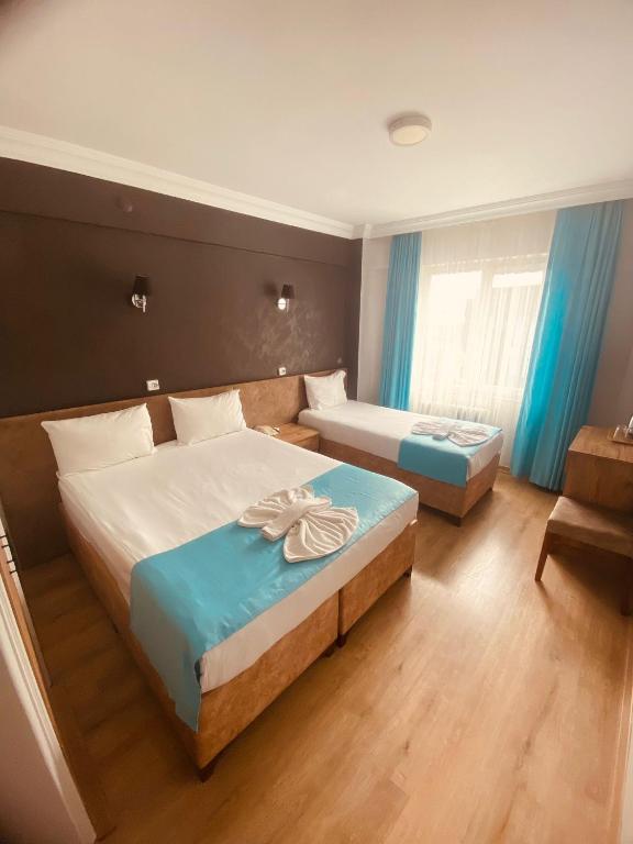 Postel nebo postele na pokoji v ubytování Malkoç Hotel