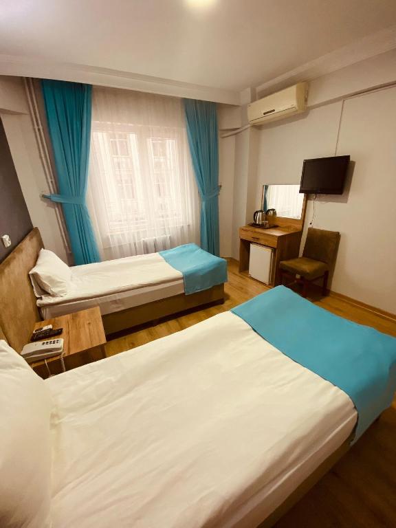Postel nebo postele na pokoji v ubytování Malkoç Hotel