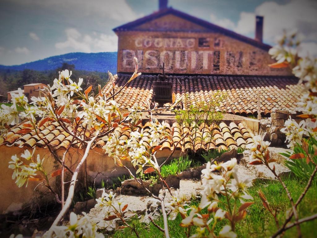a building with a sign on the side of it at Bastide Napoléon in Séranon