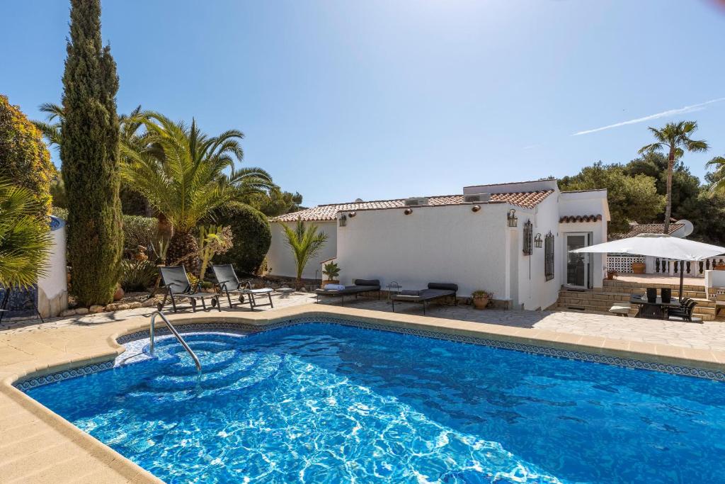 a swimming pool in front of a house at Casa Nero in Jávea