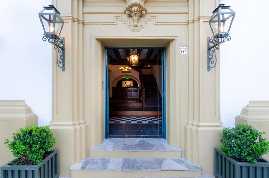 una entrada a un edificio con dos macetas en El Bodeguero Hotel en Salta