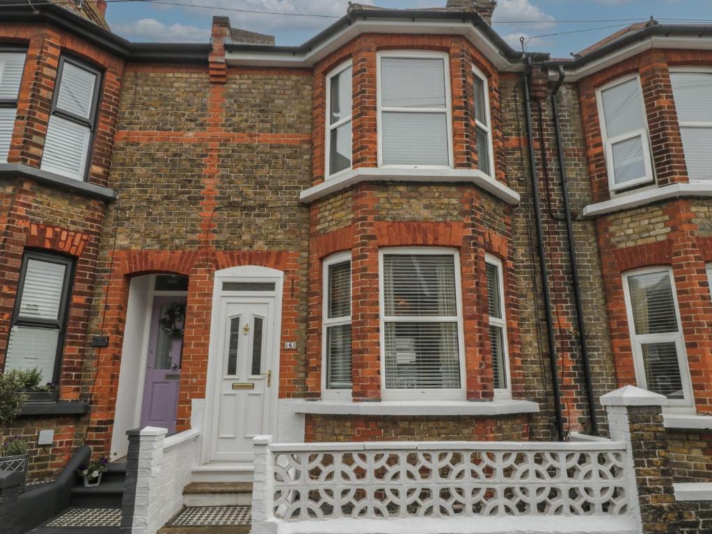 a large brick house with a white door at 6 Sydney Road in Ramsgate