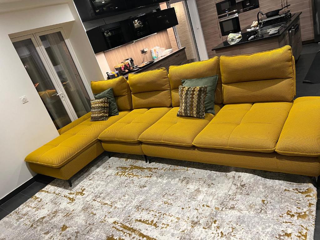 a yellow couch in a living room at Haddad in Persan