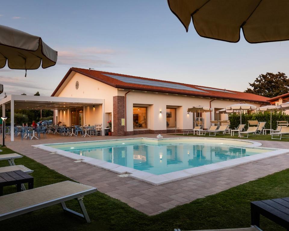 a swimming pool in front of a building at Agriturismo Acquachiara in Sabaudia
