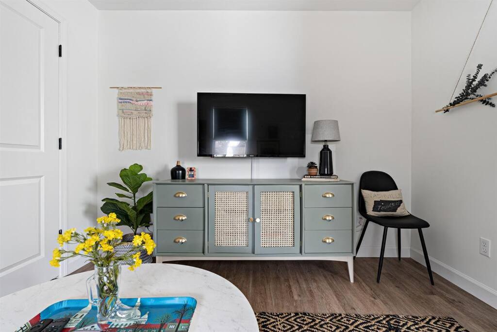 a living room with a tv on top of a dresser at Southbound Stays - Little House in Nashville