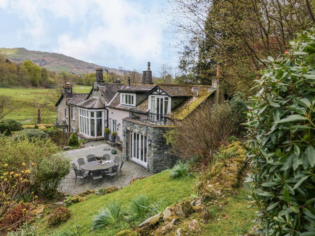 an old house with a table in front of it at River Lodge in Ambleside