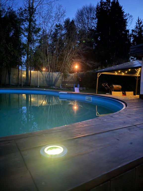 a swimming pool at night with lights in it at Bungalows Sonnenblume Klopeiner See in Sankt Kanzian