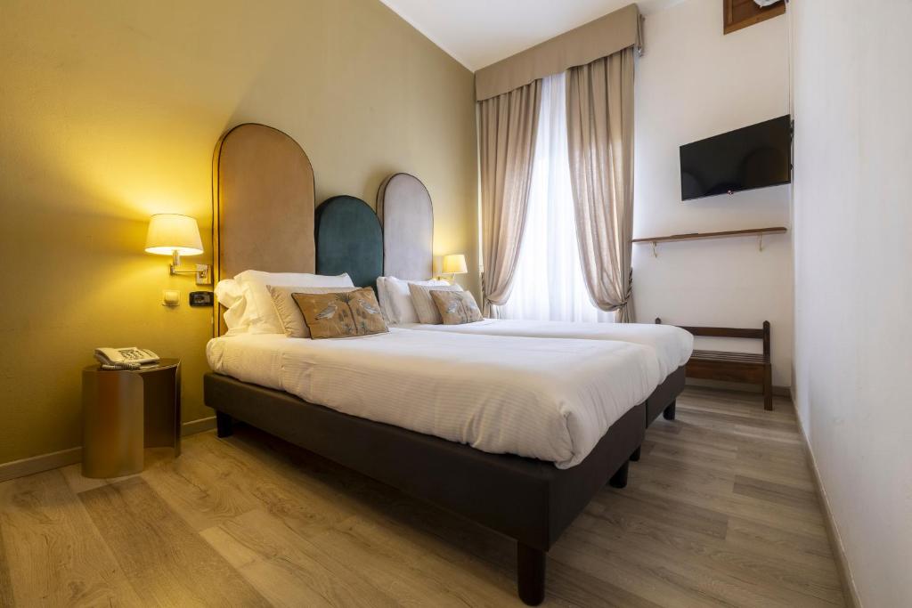 Postel nebo postele na pokoji v ubytování Hotel Bagliori