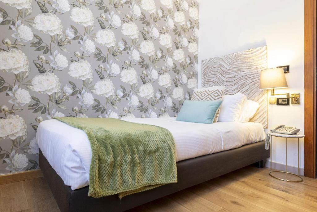 Postel nebo postele na pokoji v ubytování Hotel Bagliori